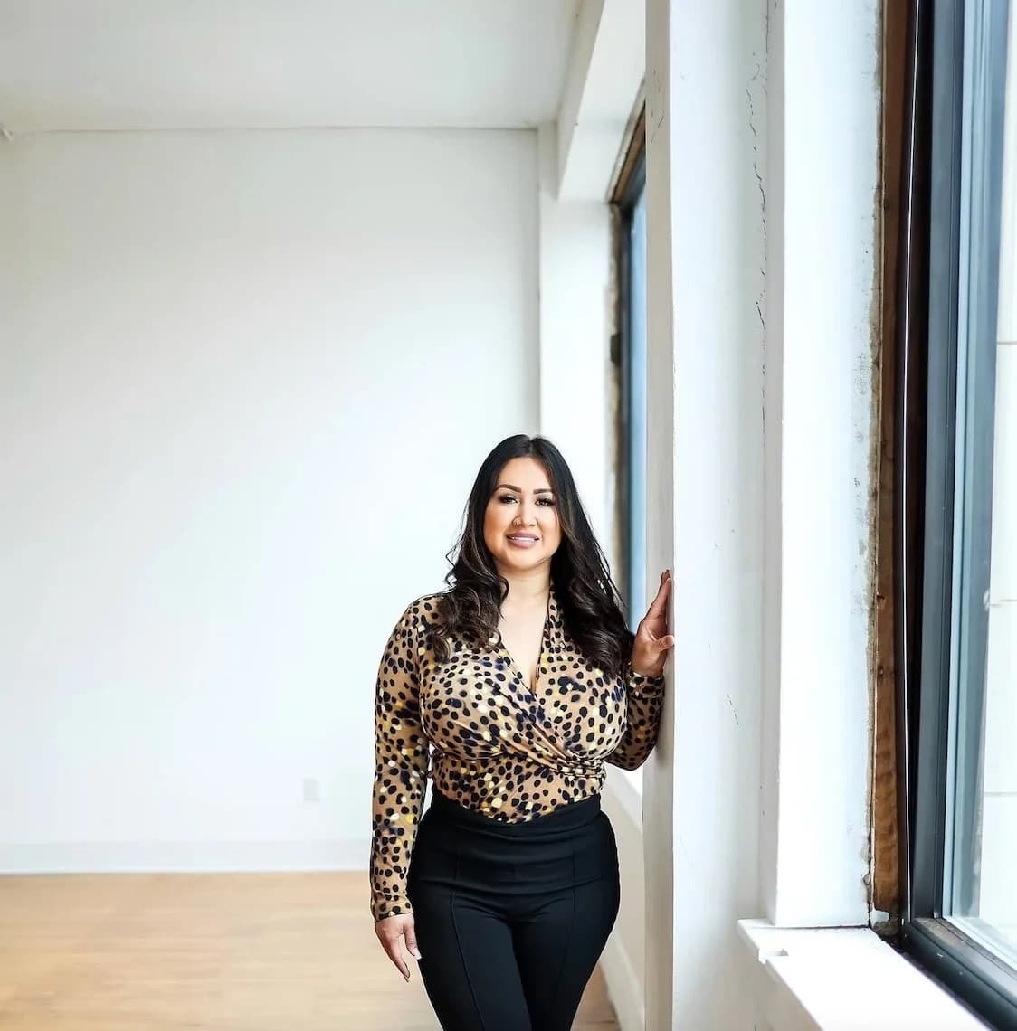 Stephanie Perez, founder of Neat & Clean Services, standing by a bright window