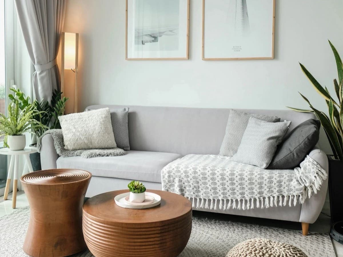 Bright, guest-ready living room with a neatly styled sofa